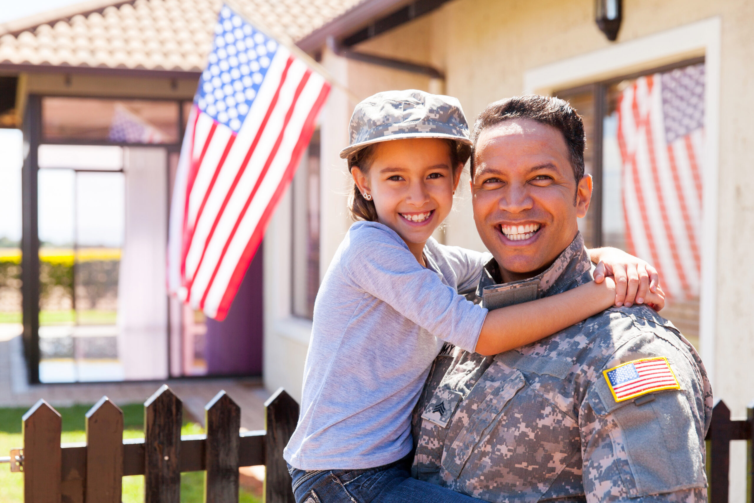 Smiling Veteran Holding Daughter